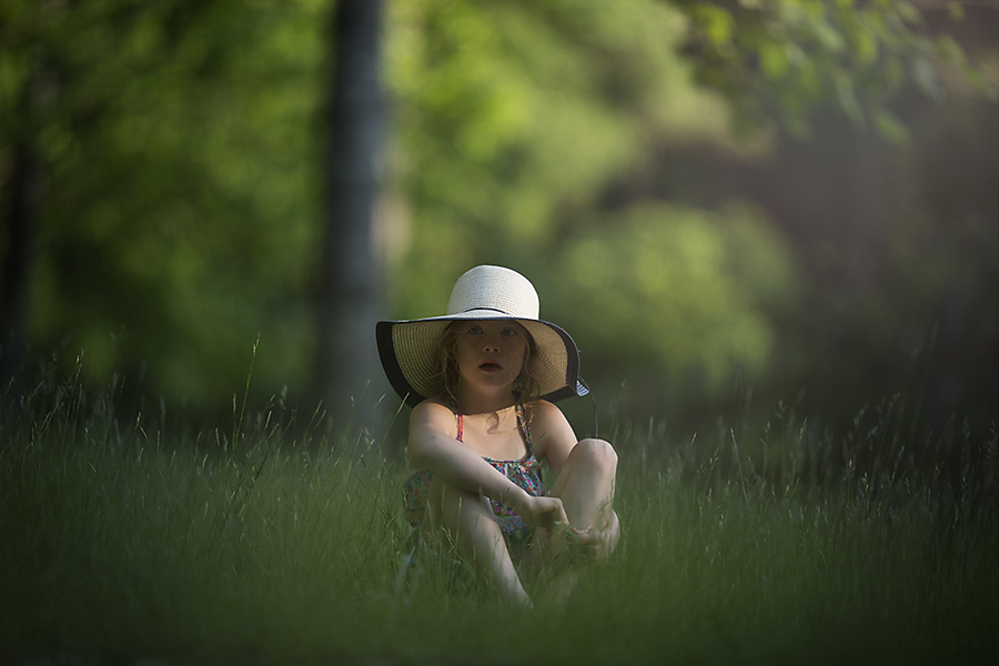 Natural Light Photography Outdoors. Girl sitting in the Grass