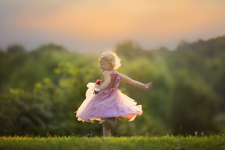 Little girl in pink dress twirling