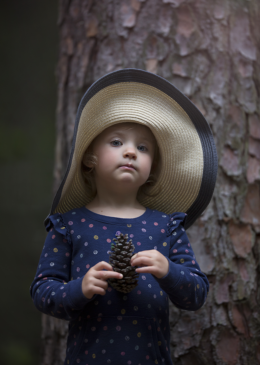 Child Photography Little girl with pinecone