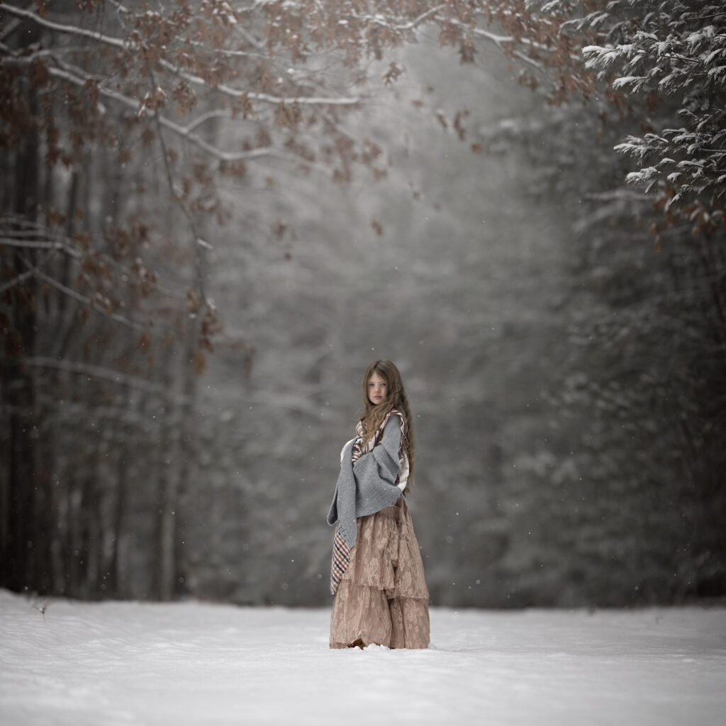Winter Light Photography. Girl posing in snowy scene.