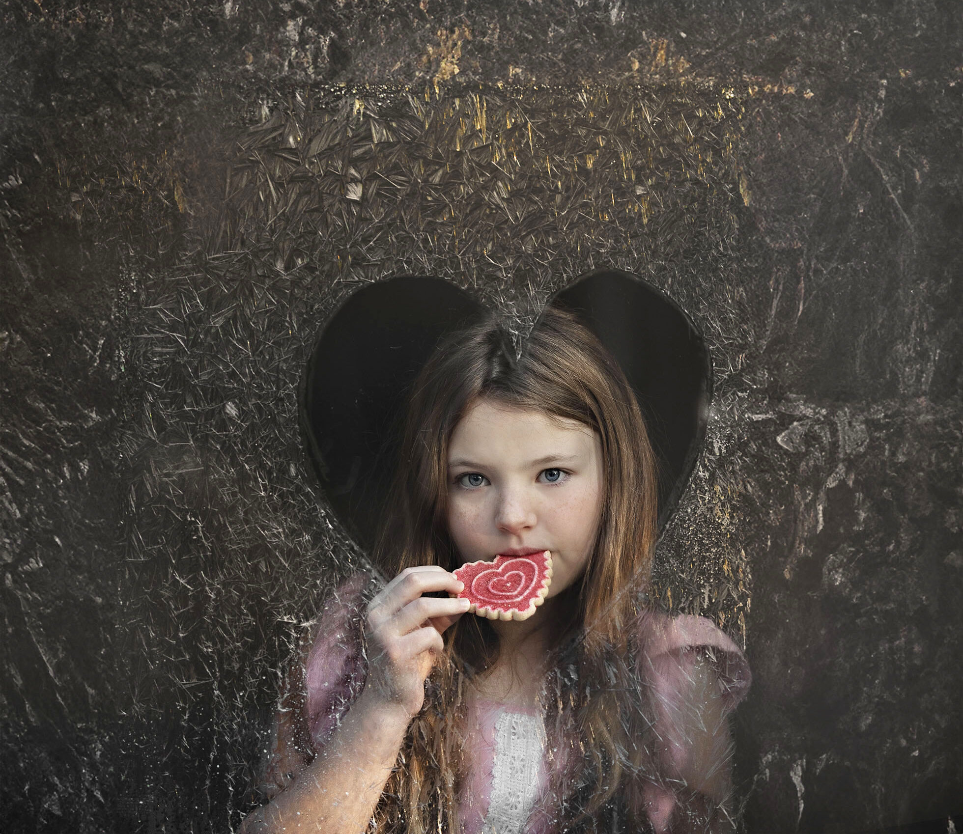 Valentines Day Photography Little girl in frosty window eating heart shaped cookie