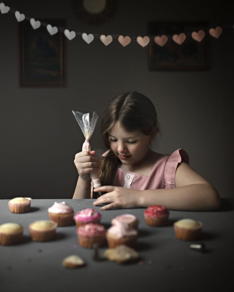 Valentines Day Photography, little girl decorating cupcakes